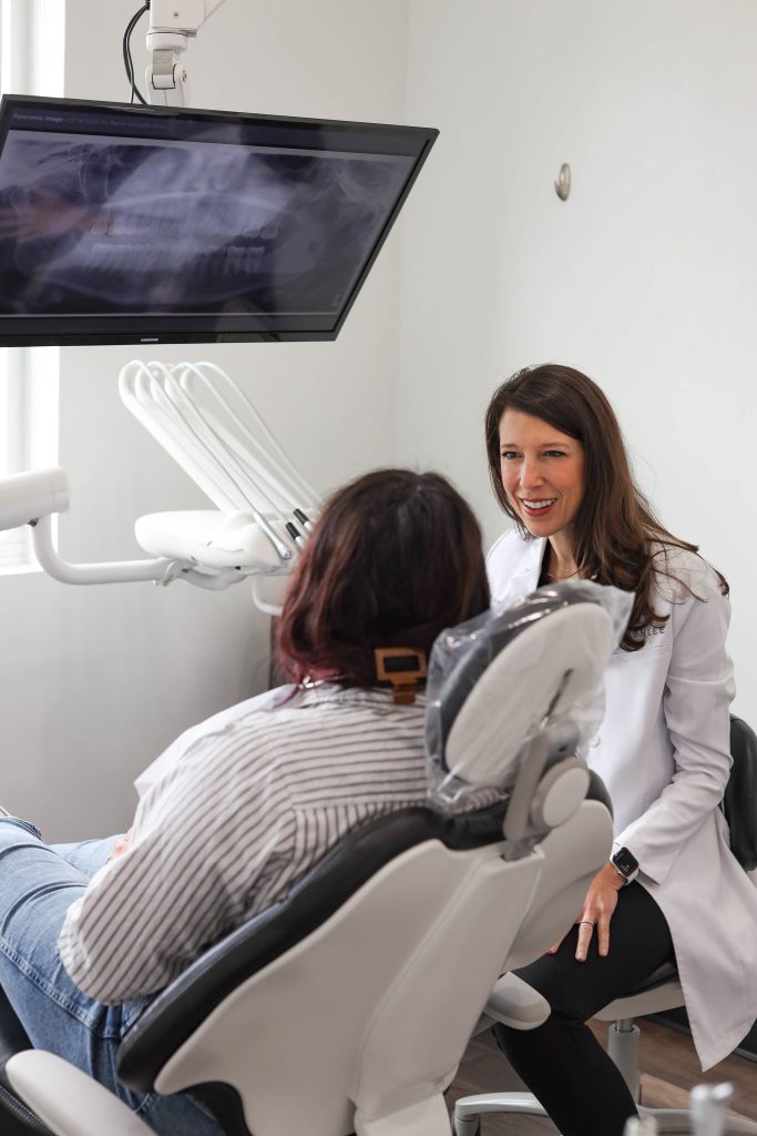 Dr. Kimberly Greenlee treating a patient in a dental operatory at Greenlee Dental